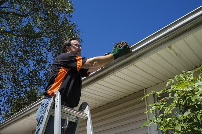 a maintenance worker fixing a leaking gutter in Atlantis